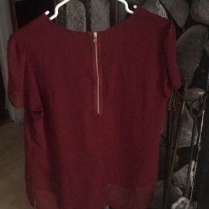 Maroon short sleeve blouse.